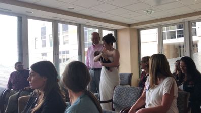 Bride carries premature baby down aisle at wedding