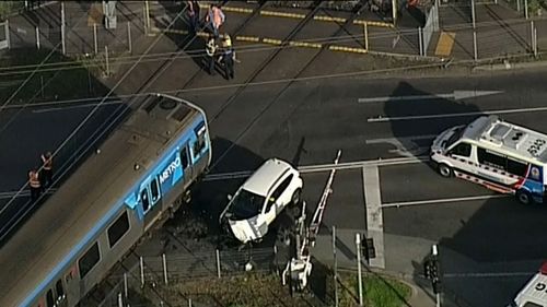 Car collides with train at Melbourne level crossing