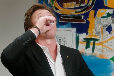 Richard Wilkins tossing back a shot of tequila at Madonna's request during their sit down interview.