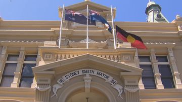 An Indigenous flag flies at half mast after the Voice referendum.