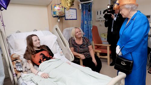The Queen speaks to Millie Robson, aged 15, from County Durham, and her mum, Marie at Royal Manchester Children's Hospital. (Supplied)