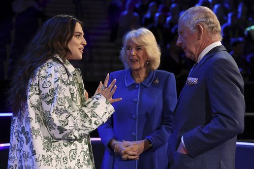 King Charles III, right, and Camilla, Queen Consort meet with Britain's Eurovision Song contestant Mae Muller, left, in Liverpool, England, Wednesday April 26, 2023 