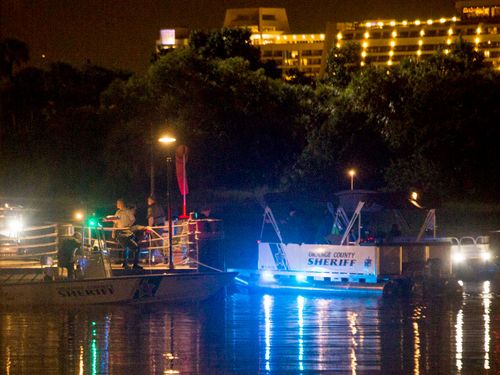 Search crews work through the night trying to locate the alligator that snatched a boy at the shore. (AAP)