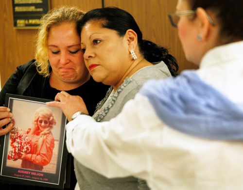 Pearl Nelson, 38, is hugged by Mary Louise Frias. Ms Nelson is holding a photo of her mother, Audrey Nelson – a victim of convicted serial killer Samuel Little. Ms Fria’s godmother, Guadalupe Apodaca Zambrano, was also a victim.