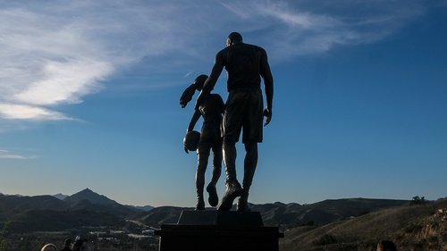 A bronze sculpture honoring former Los Angeles Lakers NBA basketball player Kobe Bryant, his daughter Gianna Bryant, and the names of those who died, is displayed at the site of a 2020 helicopter crash in Calabasas, California. (AP Photo/Ringo H.W. Chiu)