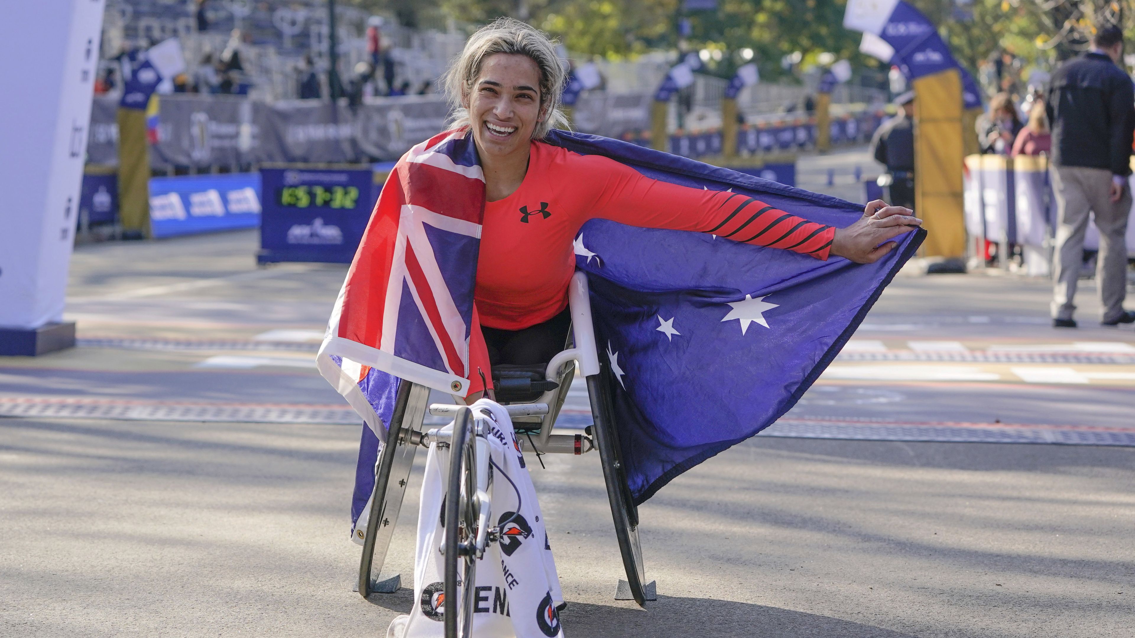 Madison de Rozario of Australia poses for a picture after crossing the finish line first in the womens wheelchair division of the New York City Marathon.