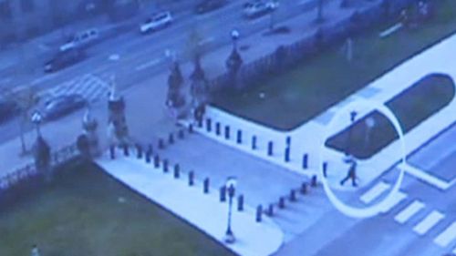 Security footage of Michael Zehaf-Bileau near the Canadian Parliament armed with a gun. (AAP) 