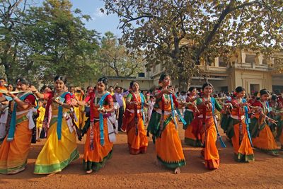 Students of Visva-Bharati University perform a dance followed by singing in a to celebrate Basanta Utsav to mark 'Holi' (festival of colour). 
