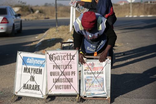 A newspaper vendor offers daily newspapers with headlines regarding the protests in Harare, Zimbabwe, 02 August 2018 on the day after violent protests in the Zimbabwean capital. Media reports say that at least three people were killed during protests after Zimbabwe National Army soldiers fired live bullets at protestors whom were believed to be supporters of the MDC. Oppositional MDC leader Nelson Chamisa was quoted as having called the 30 July election rigged. Zimbabwe held its first post-Mugabe era elections for president, parliament and local councils on 30 July. EPA/AARON UFUMELI