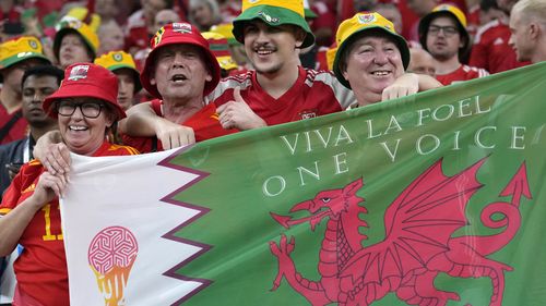 Fans cheer ahead the World Cup, group B soccer match between the United States and Wales, at the Ahmad Bin Ali Stadium in in Doha, Qatar, Monday, Nov. 21, 2022