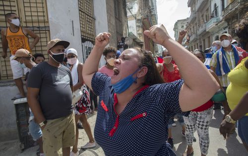 A woman shouts during a an anti-government protest in Havana, Cuba, Sunday, July 11, 2021. (AP Photo/Ismael Francisco)