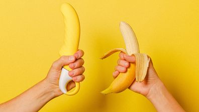 Banana and vibrator being held up