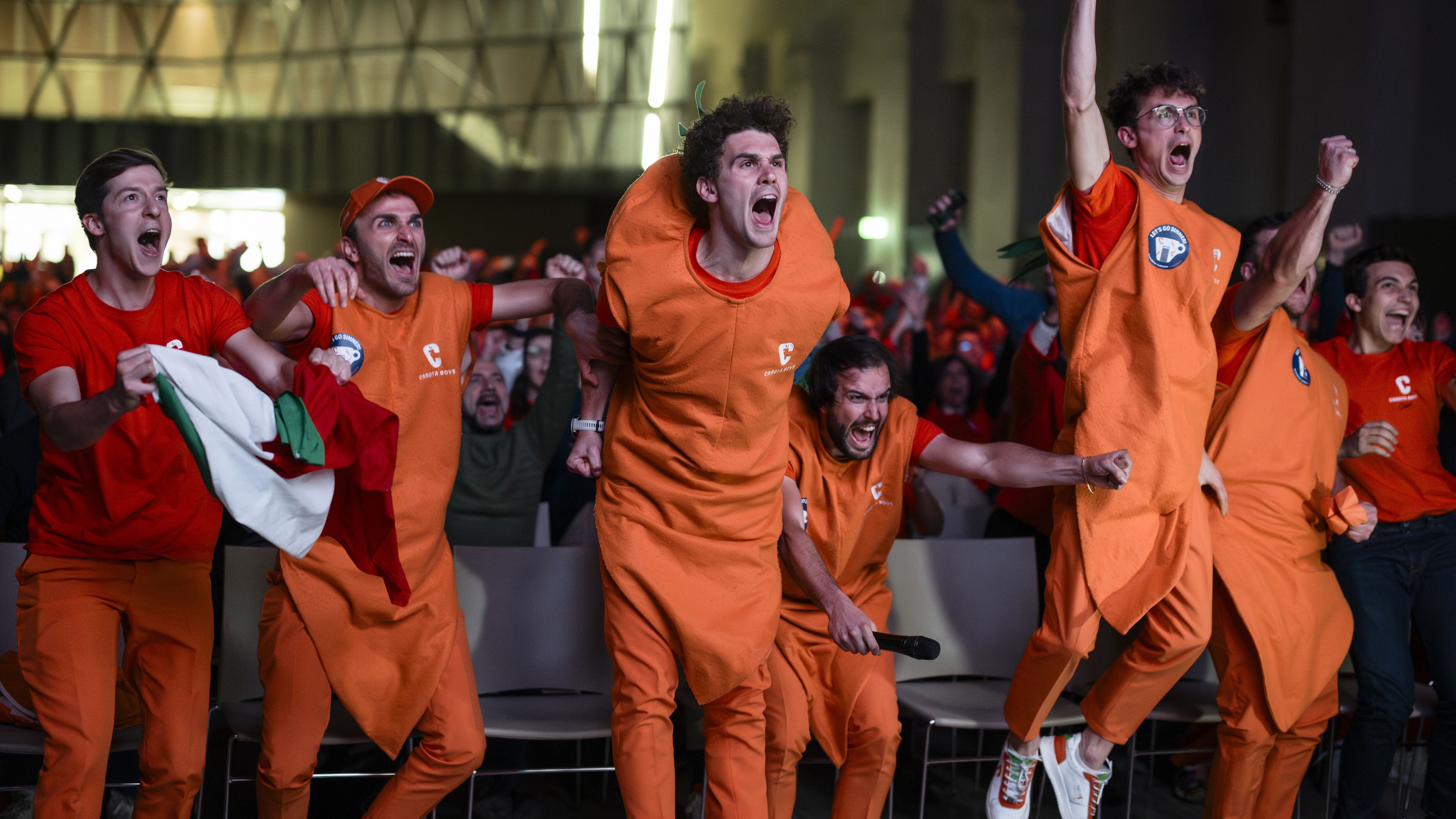 NUVOLA LAVAZZA, TURIN, ITALY - 2024/01/28: The &#x27;Carota Boys&#x27; (a group of fans of Jannik Sinner dressed up as carrots) celebrate a point during an event organized at Nuvola Lavazza to watch live on a big screen the Australian Open Final between Jannik Sinner of Italy and Daniil Medvedev of Russia. Jannik Sinner won 3-6, 3-6, 6-4, 6-4, 6-3 claiming his first Grand Slam title. (Photo by Nicolò Campo/LightRocket via Getty Images)