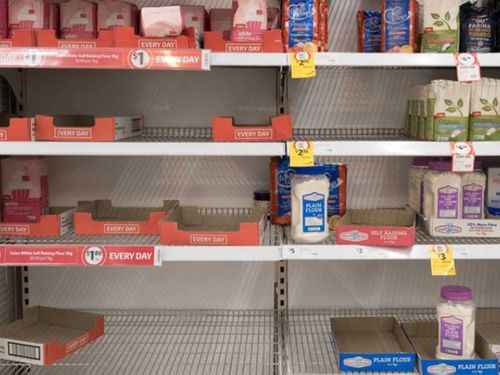 Depleted shelves of flour at the Coles supermarket in Woy Woy, NSW.