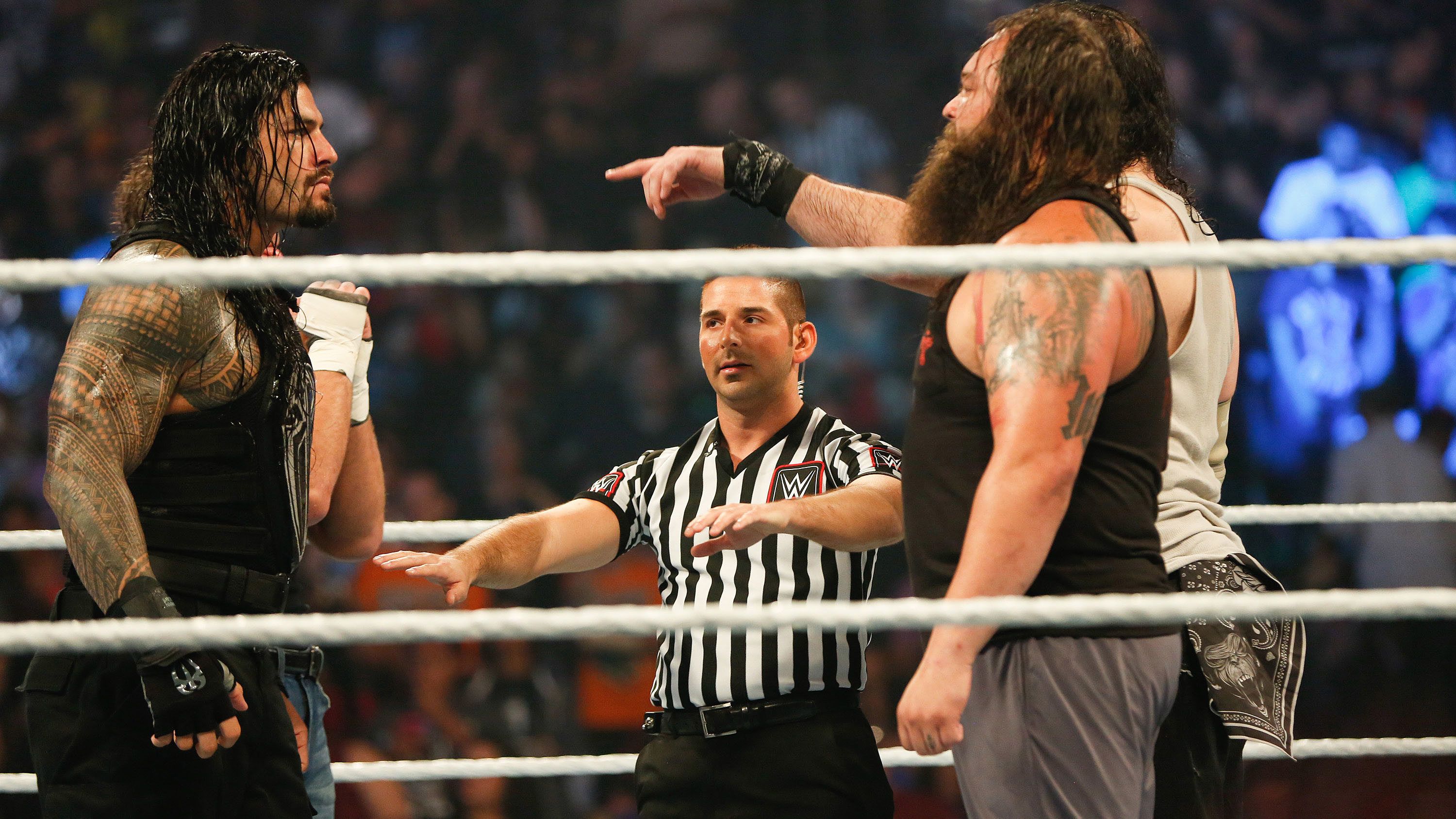 Roman Reigns and Bray Wyatt stare each other down at the WWE SummerSlam 2015.