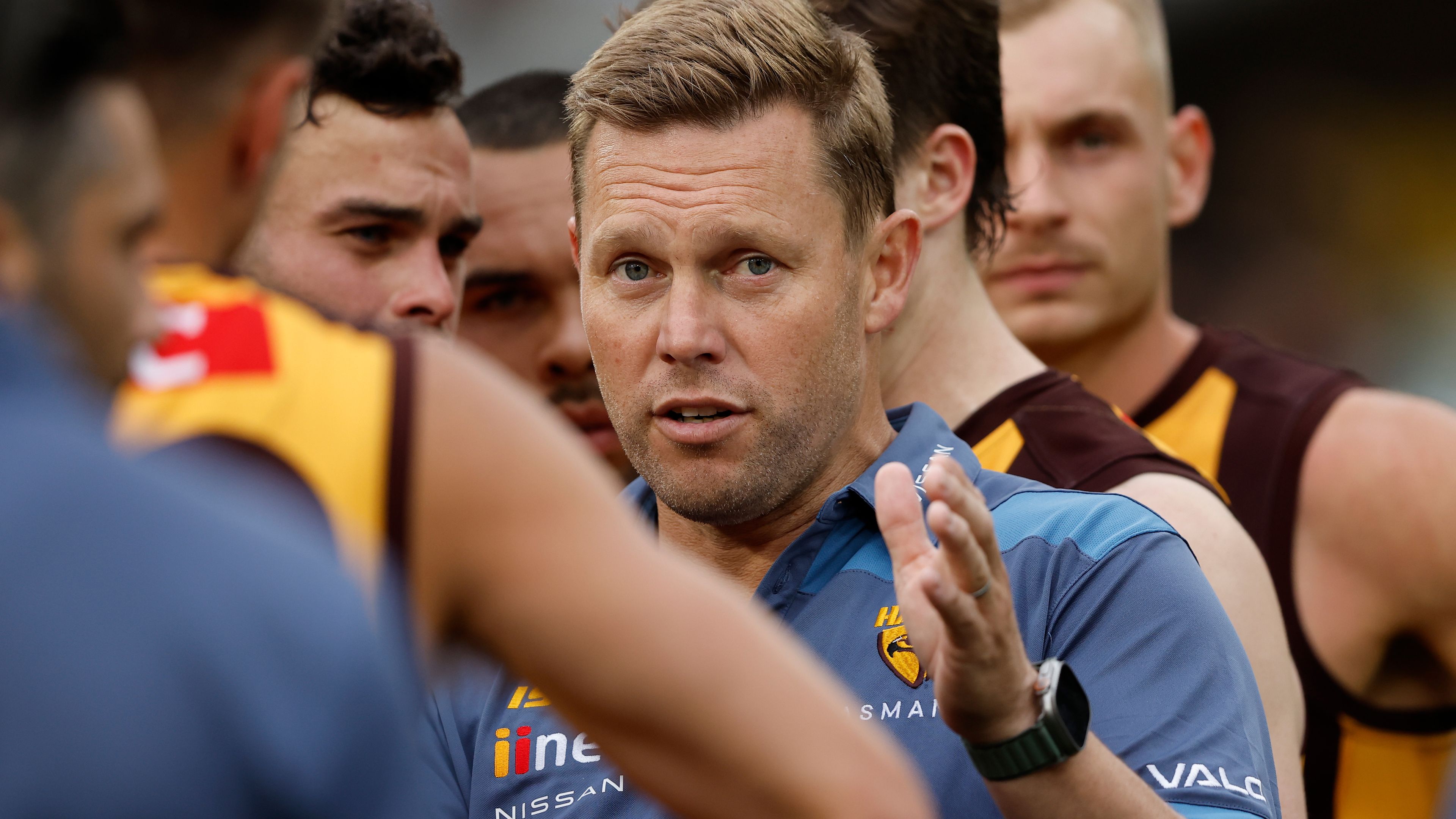 MELBOURNE, AUSTRALIA - MARCH 19: Sam Mitchell, Senior Coach of the Hawks addresses his players during the 2023 AFL Round 01 match between the Hawthorn Hawks and the Essendon Bombers at the Melbourne Cricket Ground on March 19, 2023 in Melbourne, Australia. (Photo by Dylan Burns/AFL Photos)