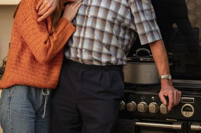 woman and grandfather in kitchen of home