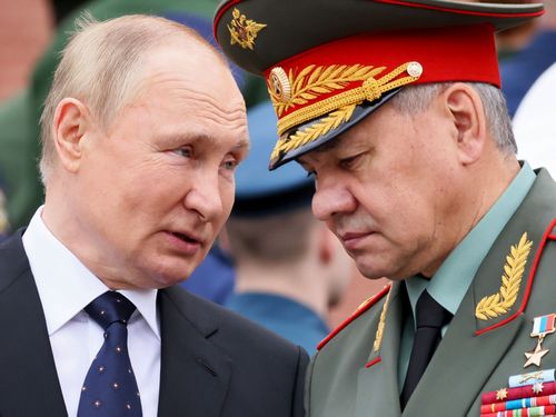 Russian President Vladimir Putin speaks with Russian Defence Minister Sergei Shoigu. 