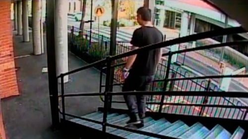 The man on video is seen clutching a mobile phone in his left hand. (Victoria Police)