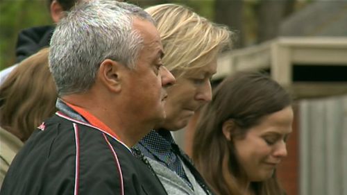 Peter and Donna pay their respects with family members. 