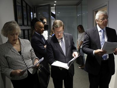 Chatham House's Chair of Panel of Senior Advisers, former British Prime Minister John Major, right, their Co-President the former Director General of British internal Security Service MI5 Eliza Manningham-Buller, left, and Panel of Senior Advisers member, the former NATO Secretary General Lord Robertson hold paperwork before taking part in a round-table exercise with Britain's Prince Harry during his visit to Chatham House, the Royal Institute of International Affairs, in London.