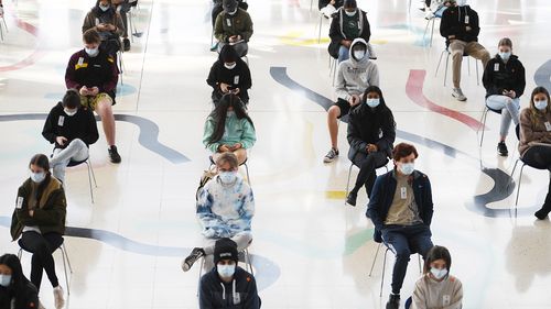 Students wait to receive the Pfizer vaccine for Covid-19 at Judos Arena, Sydney.