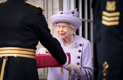 Queen Elizabeth II attends an armed forces act of loyalty parade in the gardens of the Palace of Holyroodhouse, Edinburgh, Tuesday, June 28, 2022. 