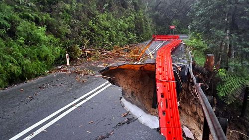 A road fell away after a months worth of rain was dumped in a day across Sydney.