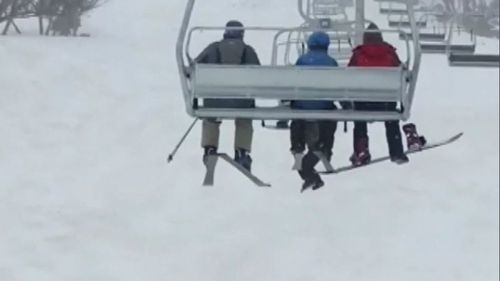 A snowboarder has been taken to hospital after falling several metres from a chairlift at New South Wales' Perisher Ski Resort.