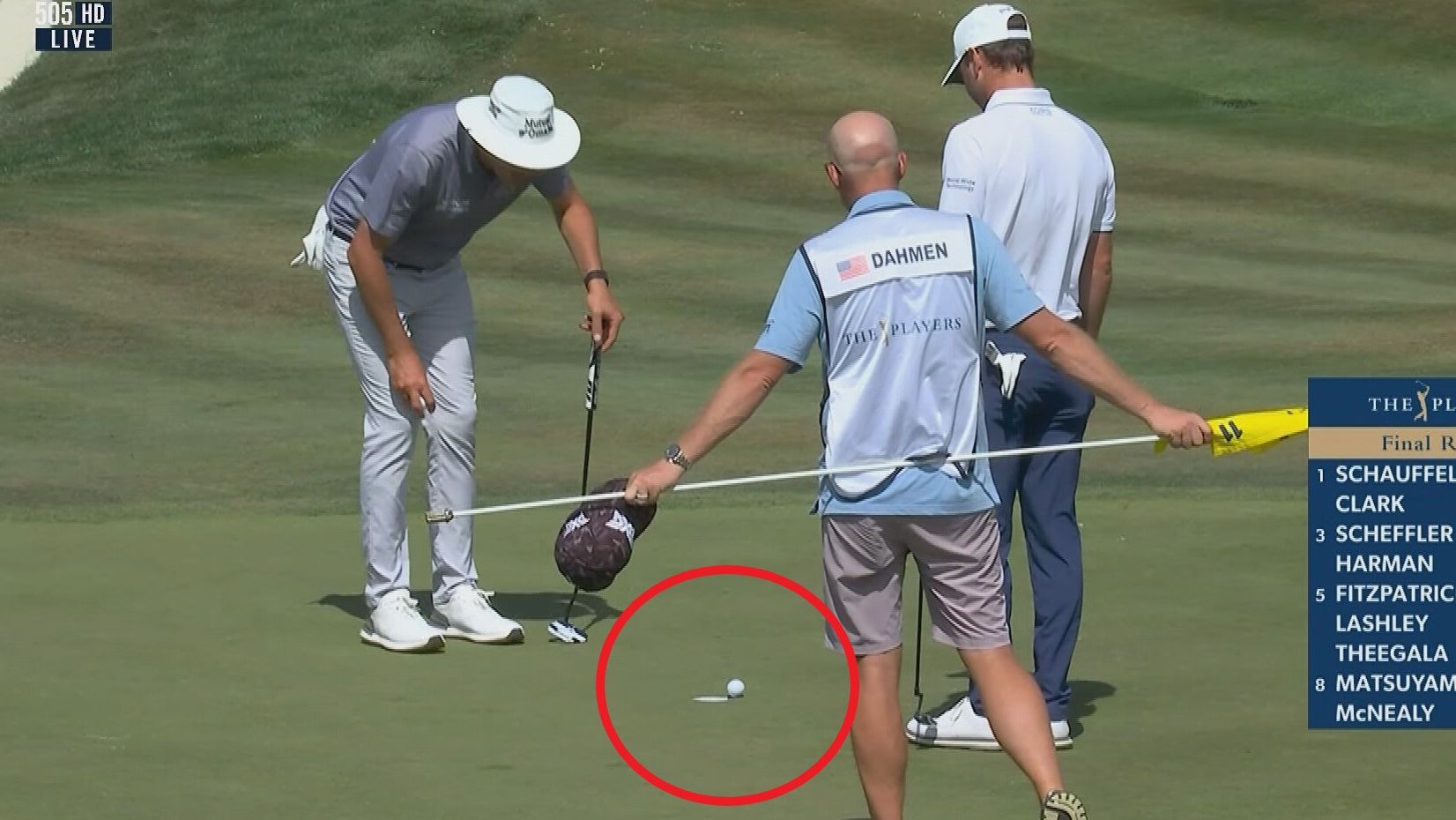 Austin Eckroat and Joel Dahmen watch Eckroat&#x27;s ball as it teeters on the edge of the cup.