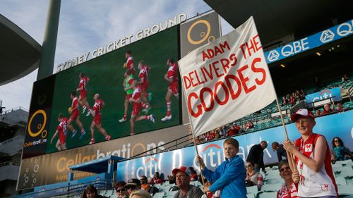 Swans fans hold a banner in support of Adam Goodes. (AAP)