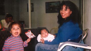 Texas death row inmate Melissa Lucio is holding her daughter Mariah, while one of her other daughters, Adriana, stands next to them. 