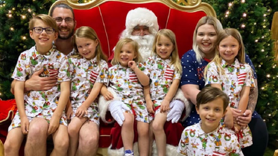 Krechelle with her husband and six children Christmas photo.