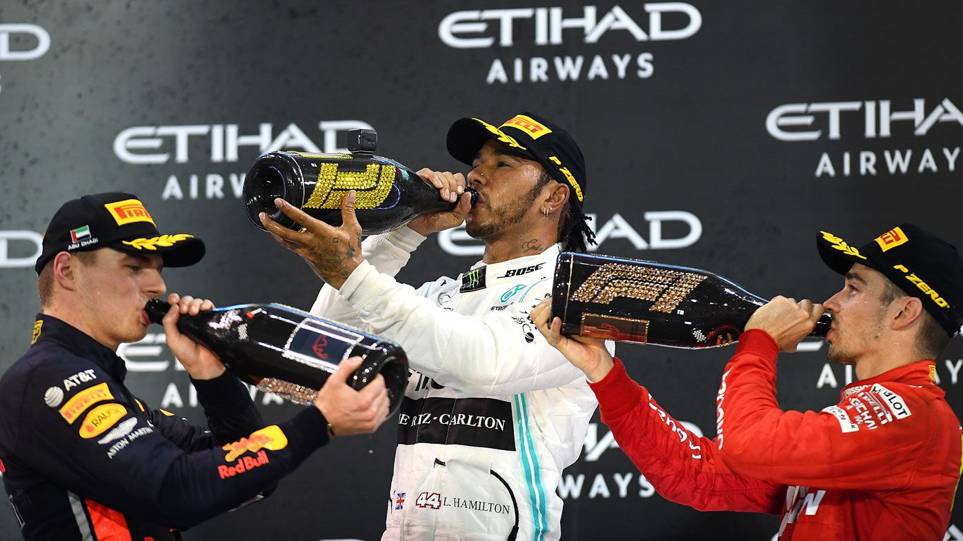 Top three finishers Lewis Hamilton of Great Britain and Mercedes GP, Max Verstappen of Netherlands and Red Bull Racing and Charles Leclerc of Monaco and Ferrari celebrate on the podium