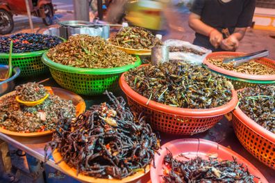 Image of variation of edible insects being sold in street market stall.