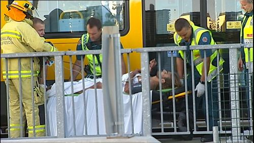 QFR crews had to lift the tram off the man to free him. (9NEWS)