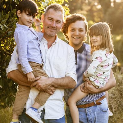 Sean Szeps with his husband and two kids