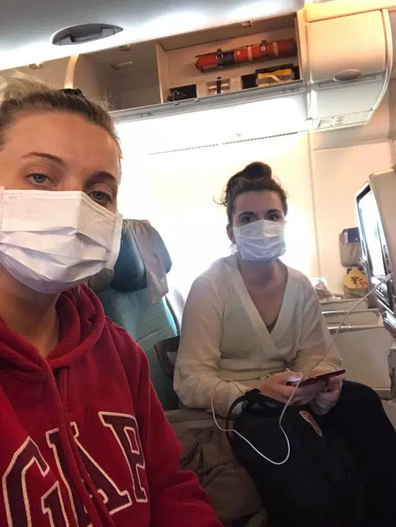 Women wearing facemasks on plane