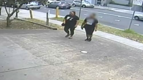 The woman is allegedly walking with Analosa Ah Keni, who was charged with Mr Ledinh's murder in March. (NSW Police)