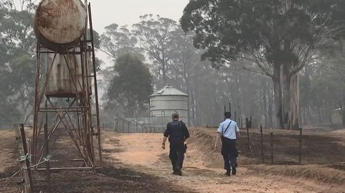 Unsure of what they will find, the police officers make their way towards the homestead, on Colin's property.