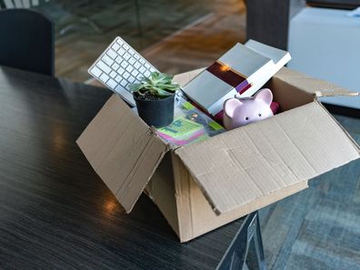 Moving office and packing belongings in a box or getting fired