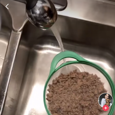 Woman washes cooked meat