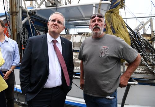 The Australian Prime Minister talks to prawn fisherman Ted Woodham during a visit to the Morton Bay Boat Club in Brisbane today.