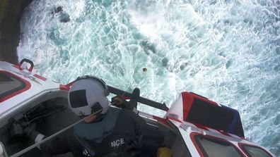 It was a dangerous task to save the stranded men, with a flight paramedic needing to be lowered into the hazardous waters below.