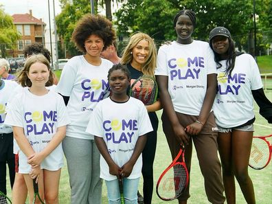 Ayan Broomfield with young tennis players in Australia during an event encouraging kids in sport.