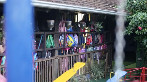 Children's backpack hang on a fence inside the "Cantinho do Bom Pastor" daycare center after a fatal attack on children in Blumenau, Brazil.