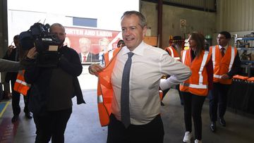 Bill Shorten dons a high vis vest during a visit to Volgren Bus Manufacturing facility in Perth.