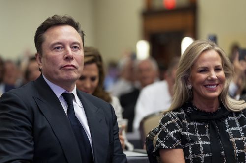 Elon Musk, left, sits with Kelly Johnson, wife of House Speaker Mike Johnson