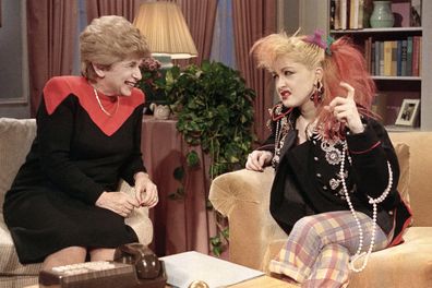 FILE - Sex therapist Dr. Ruth Westheimer talks with rock singer Cyndi Lauper in New York, Jan.  17, 1985. Westheimer, the sex therapist who became a pop icon, media star and best-selling author through her frank talk about once-taboo bedroom topics, died on Friday, July 12, 2024. She was 96. (AP Photo/ Nancy Kaye, File)