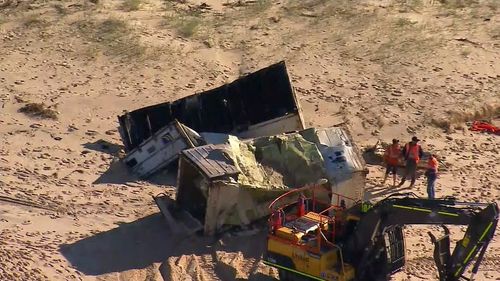 Workers are trying to clean up the debris.